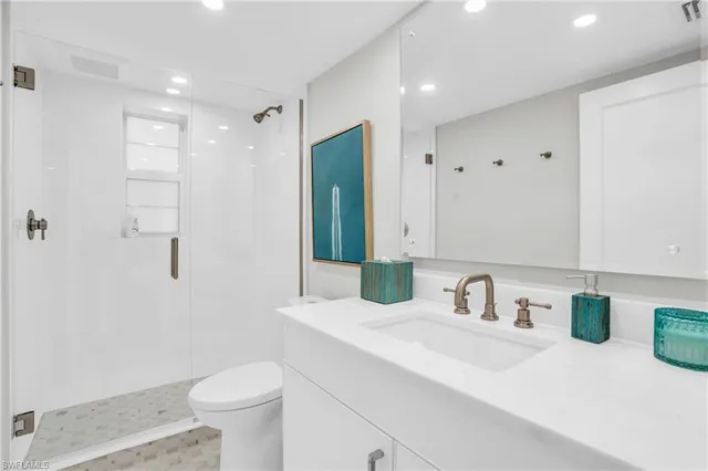 a bathroom with a sink toilet and shower