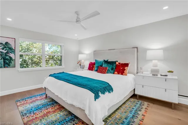 a bed room with a bed and a painting on the wall