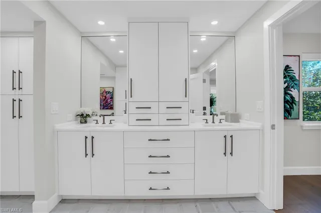 a view of white cabinets and sink