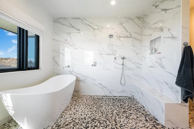 a bathroom with a bathtub and shower