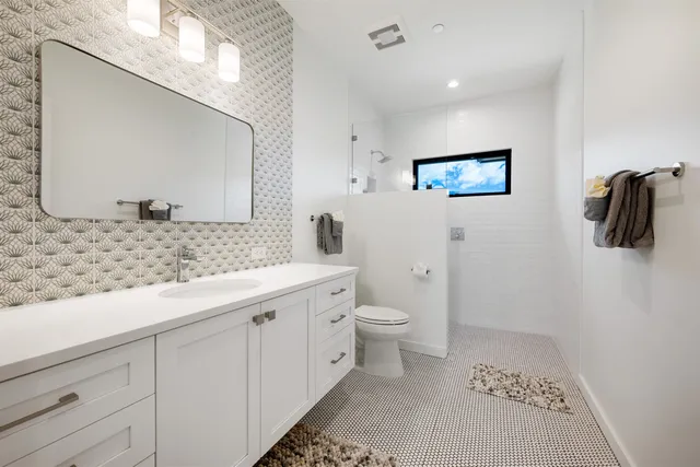 a bedroom with a bed and a night stand