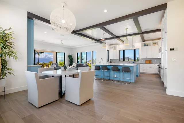 a kitchen with stainless steel appliances kitchen island a large counter top and wooden floors