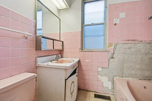 a bathroom with a sink toilet and mirror