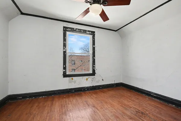 a view of a room with wooden floor and window