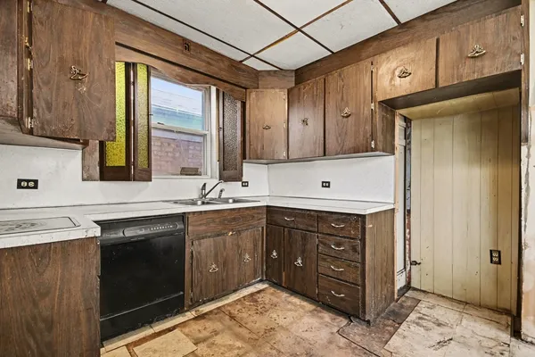 a kitchen with stainless steel appliances granite countertop a sink and cabinets