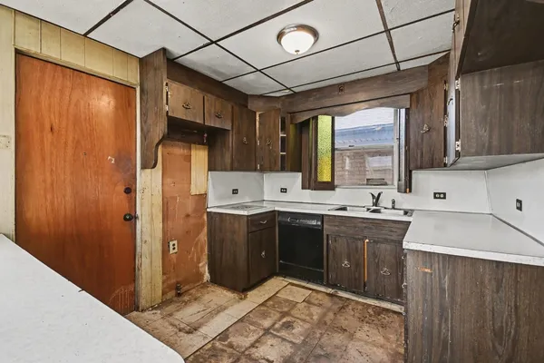 a kitchen with refrigerator cabinets and a sink