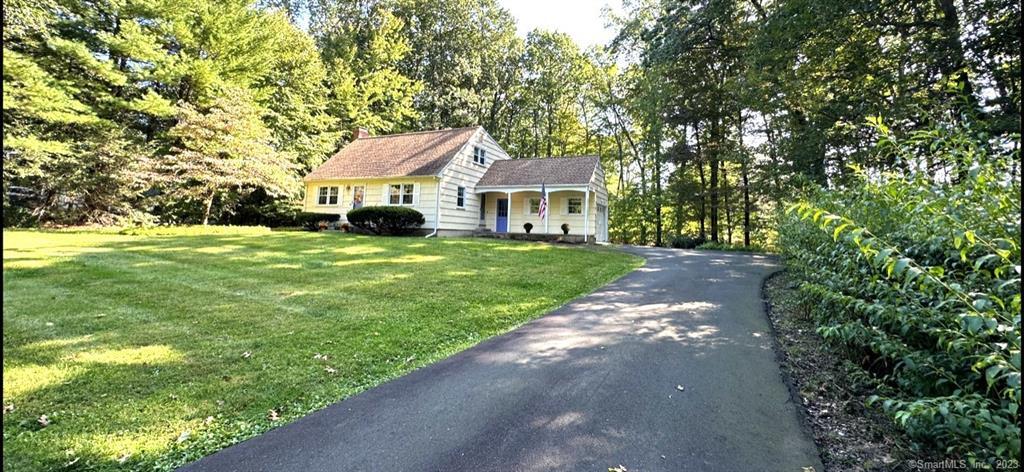a front view of a house with yard and green space