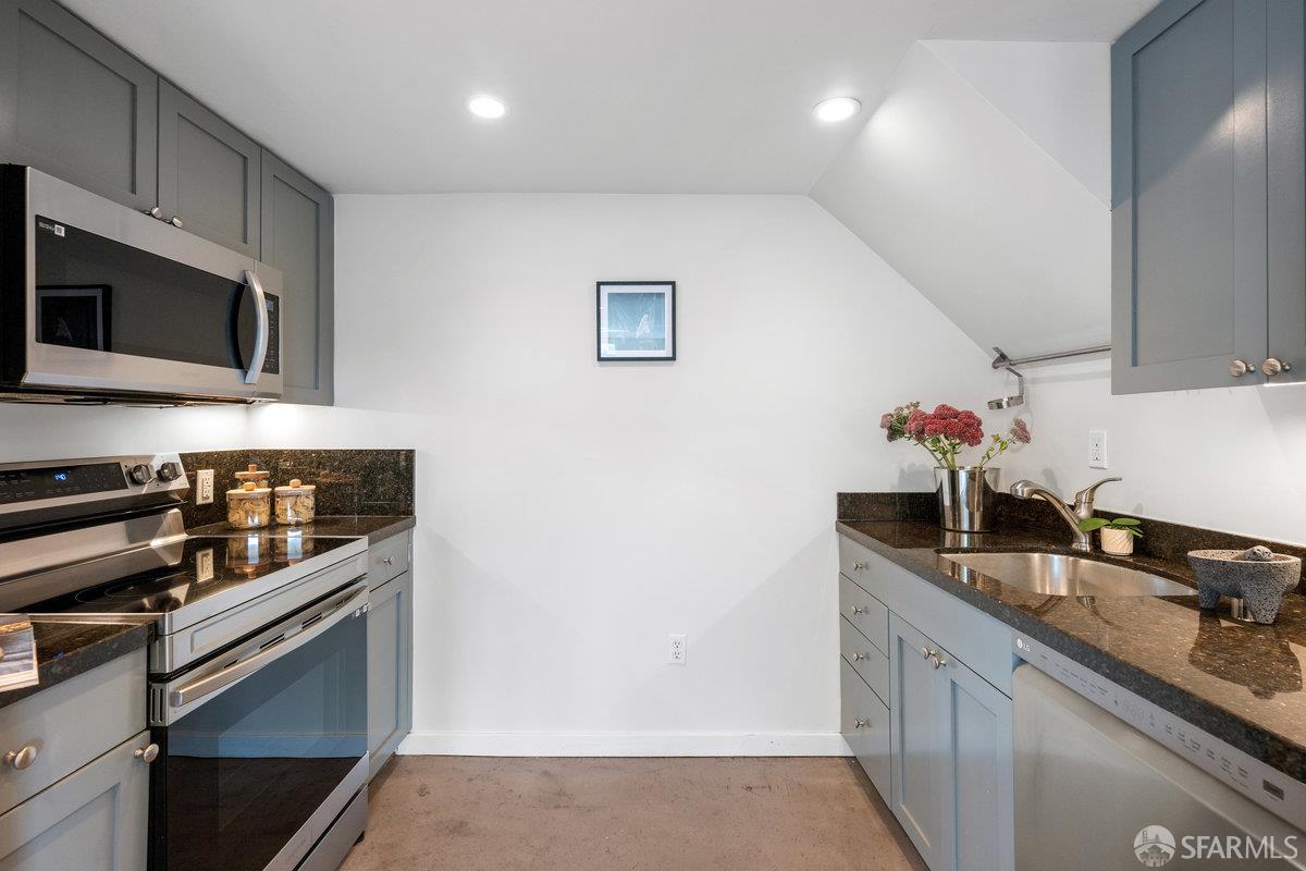 1325 Indiana Street, Unit 301 San Francisco, CA 94107 - Photo 18 of 41 a kitchen with stainless steel appliances granite countertop a sink stove and microwave
