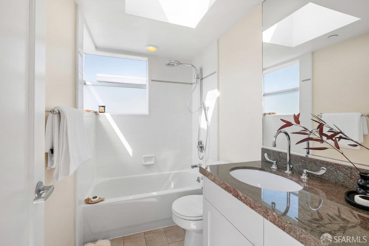 1325 Indiana Street, Unit 301 San Francisco, CA 94107 - Photo 24 of 41 a bathroom with a granite countertop sink toilet and shower