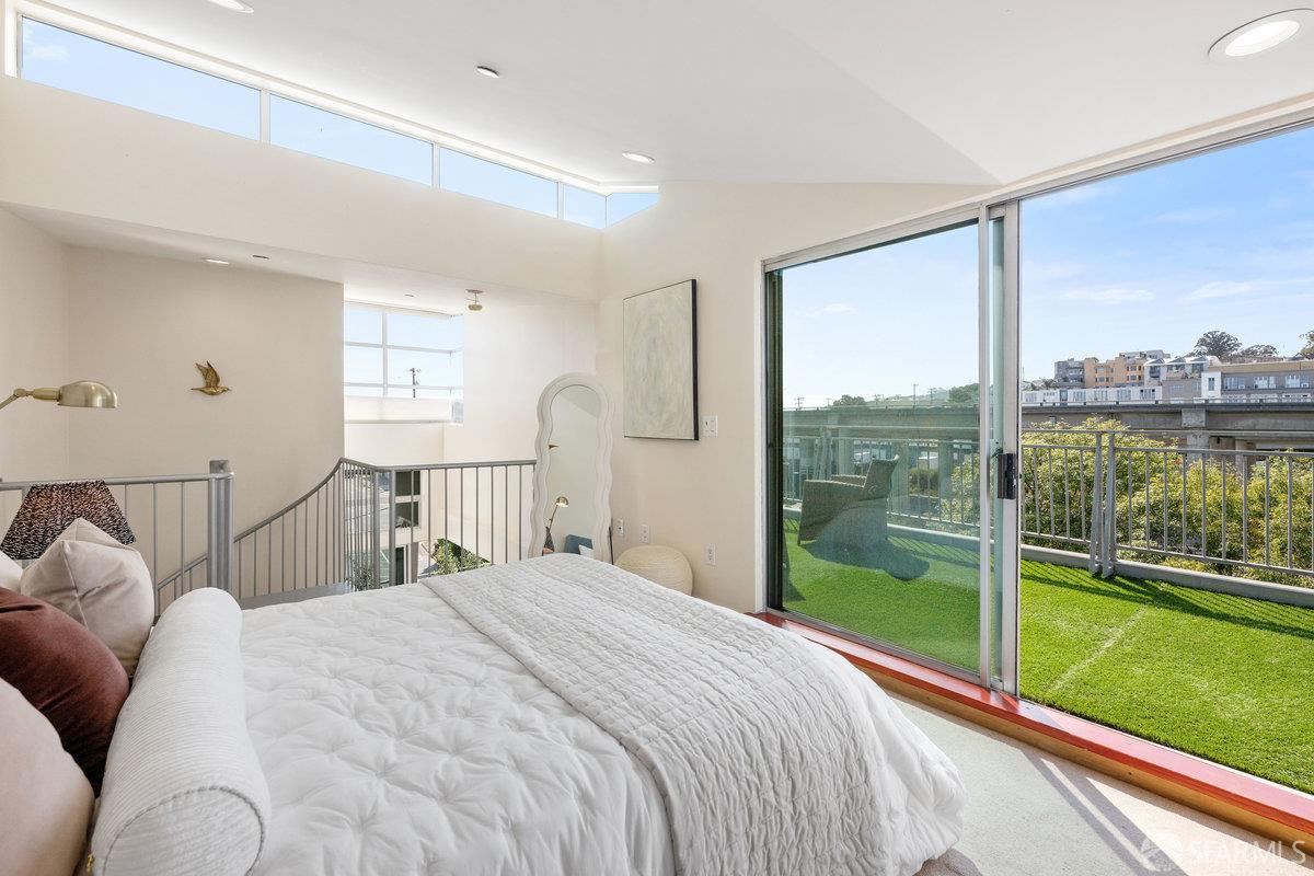 1325 Indiana Street, Unit 301 San Francisco, CA 94107 - Photo 26 of 41 a bedroom with a large bed and a view of balcony