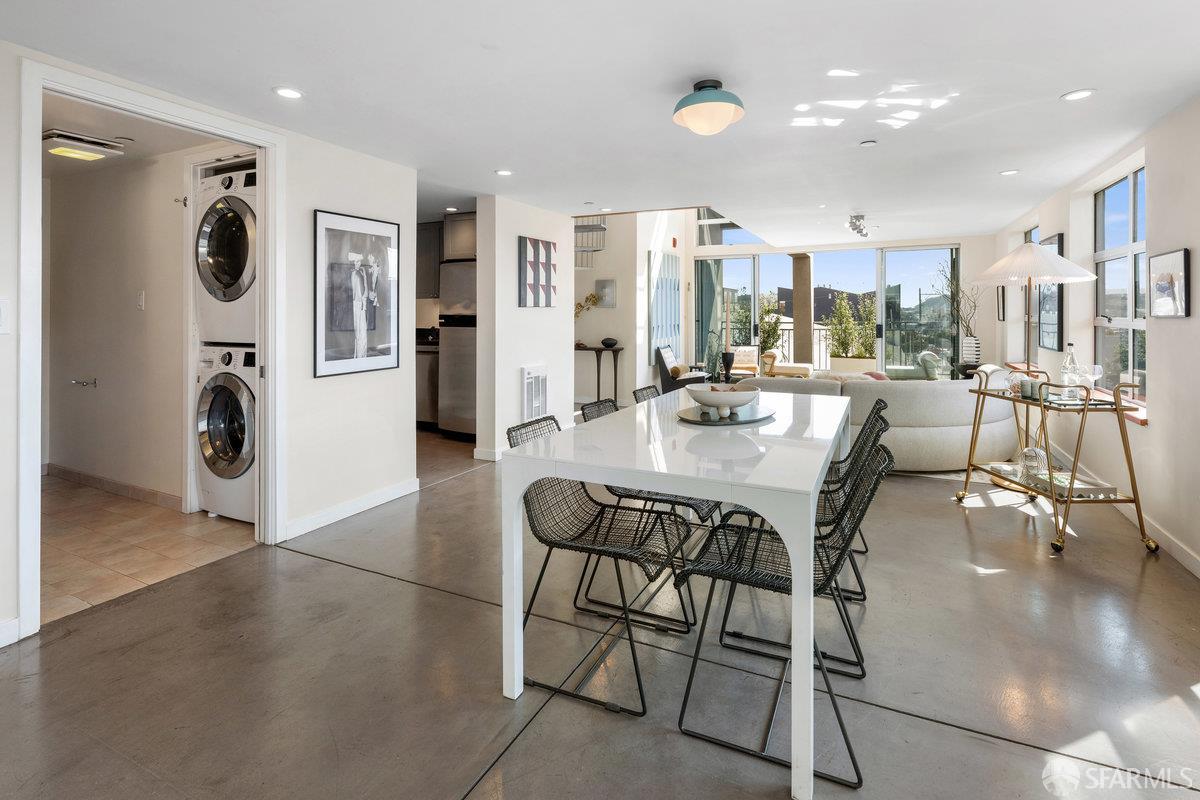 1325 Indiana Street, Unit 301 San Francisco, CA 94107 - Photo 10 of 41 a dining room with stainless steel appliances kitchen island granite countertop a table and chairs