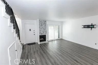 wooden floor in an empty room with a fireplace