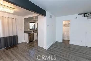 a view of kitchen with wooden floor electronic appliances and furniture