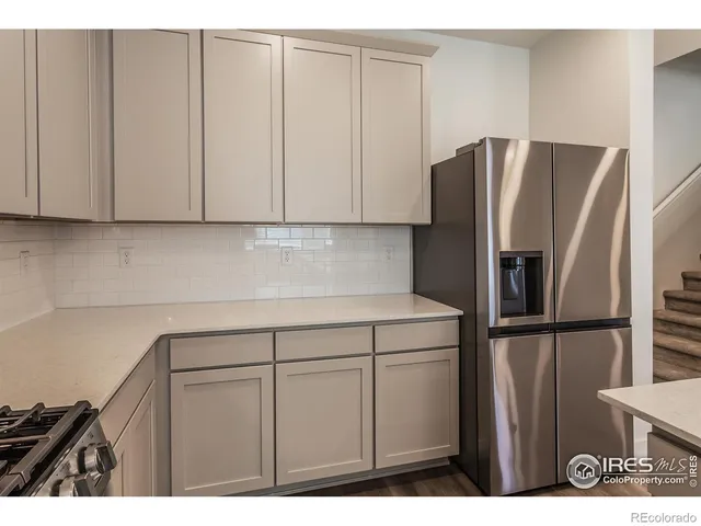 a kitchen with a refrigerator and cabinets