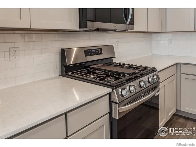 a kitchen with a stove and a microwave