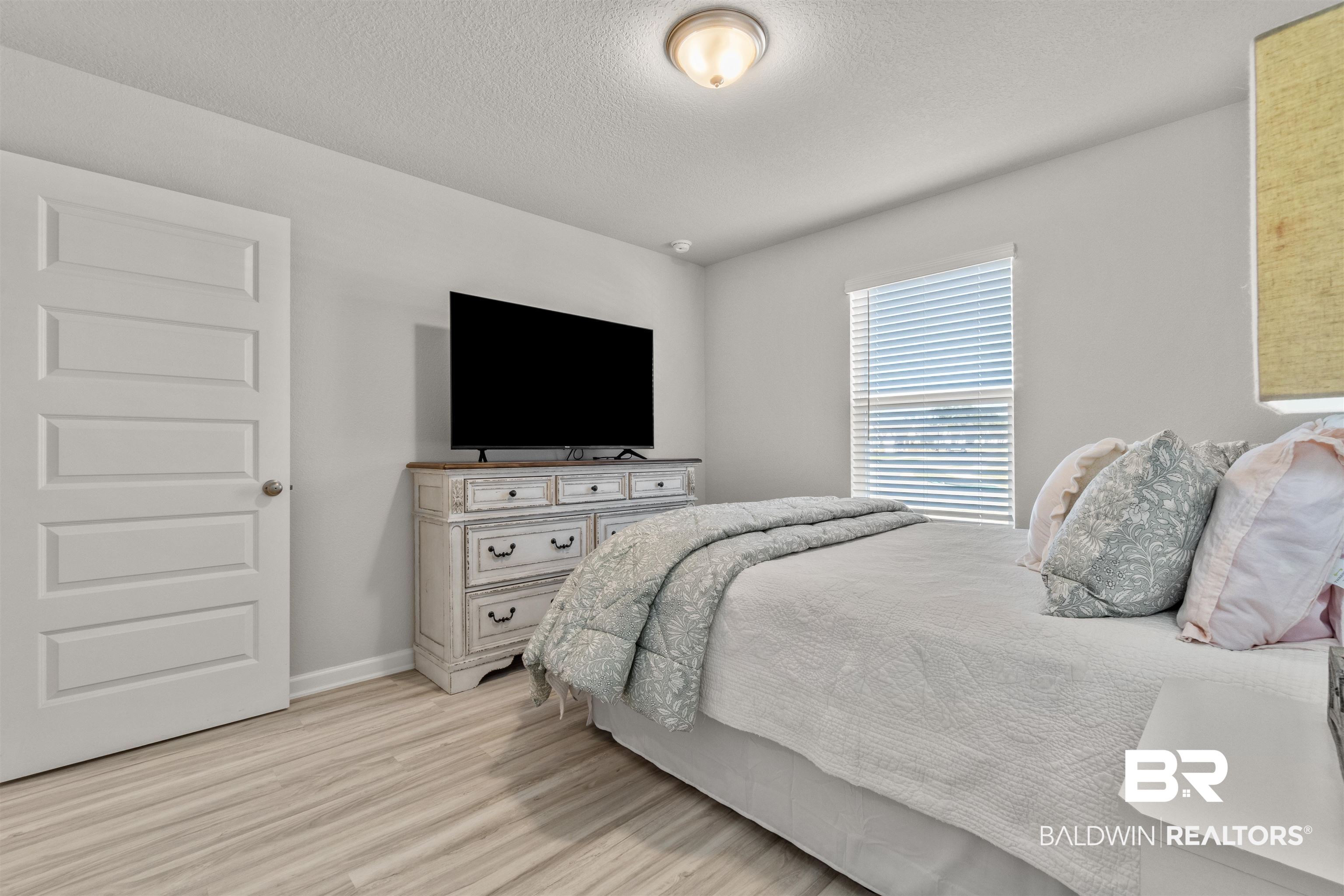 24472 Ringneck Loop Elberta, AL 36530 - Photo 32 of 46 Bedroom with light hardwood / wood-style flooring and a textured ceiling