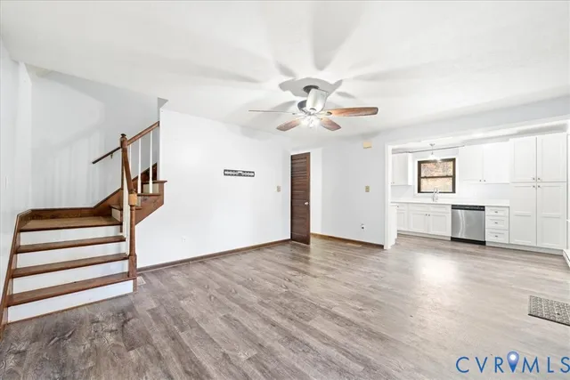 an empty room with wooden floor and window