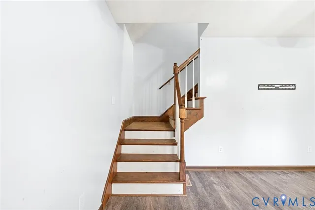 a view of a livingroom with wooden floor and a ceiling fan