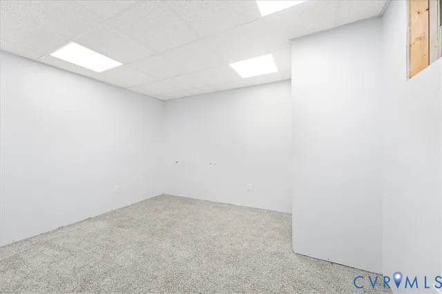 a view of a hallway with a white door and a window