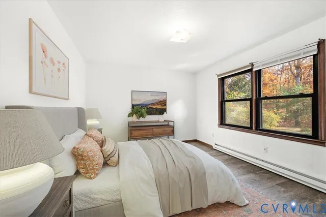 a bedroom with a bed and a large window