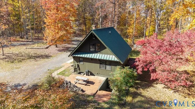 a view of a house with a yard and wooden fence