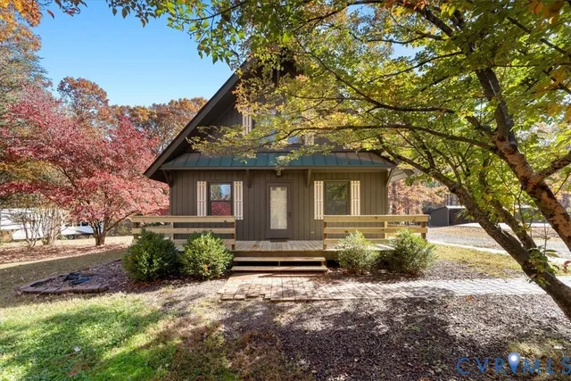 front view of a house with a tree in the yard