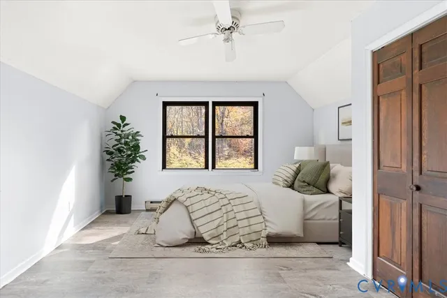 a bedroom with a large bed and a window