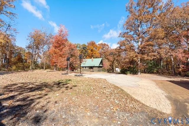 a view of a yard with snow on the road
