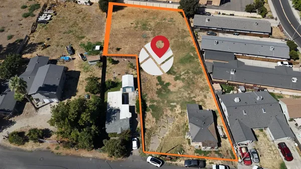 an aerial view of a house with a yard
