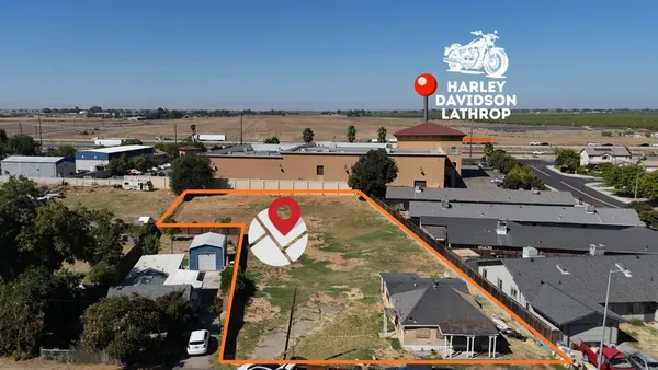 an aerial view of a building with yard