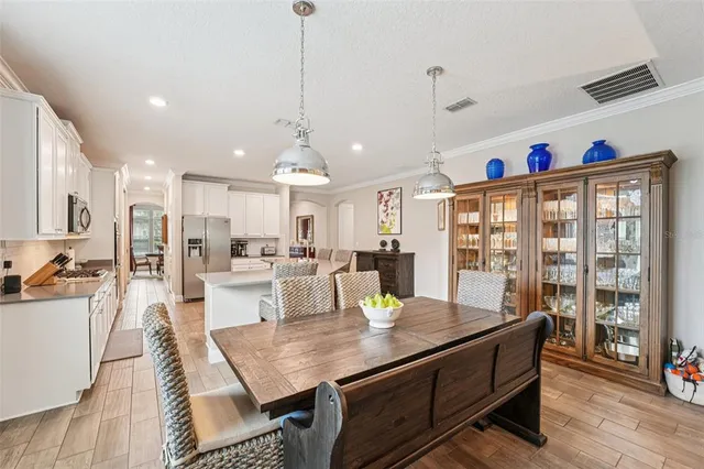 a large kitchen with a table and chairs