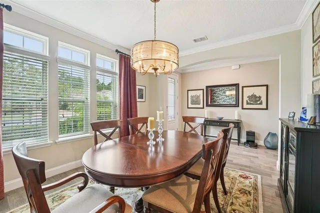 a kitchen with white cabinets and sink