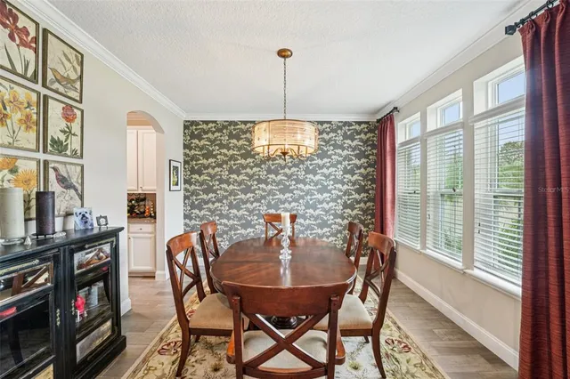 a large white kitchen with stainless steel appliances granite countertop a lot of counter space and a sink