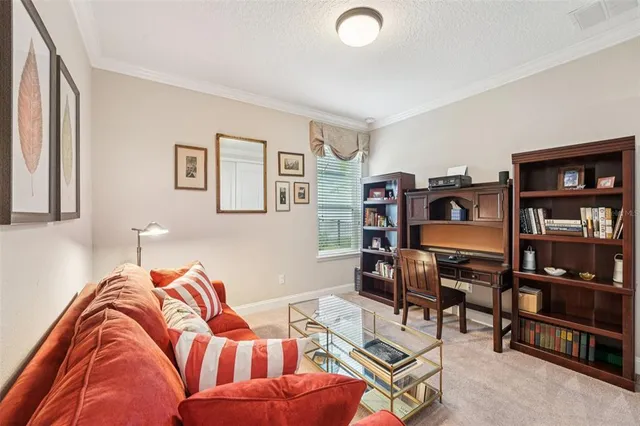 an aerial view of a house with a yard and lake view in back