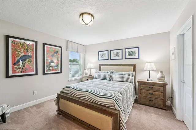 an aerial view of a house with a garden and lake view