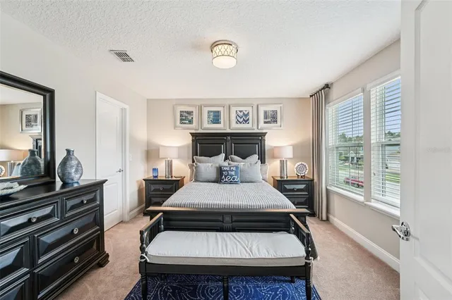 a view of a swimming pool with a table and chairs under an umbrella