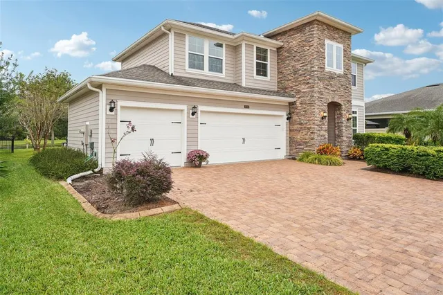 a living room with furniture kitchen view and a large window