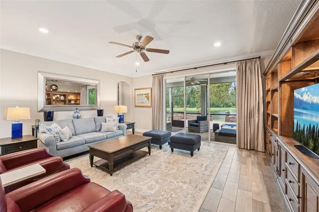 a dining room with furniture a chandelier and wooden floor