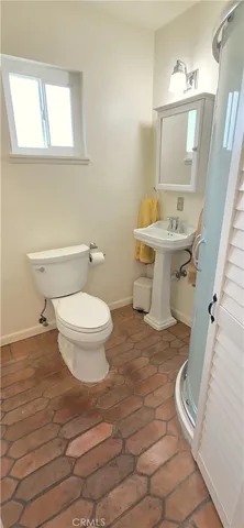 a bathroom with a sink toilet and mirror
