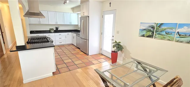 a kitchen with a sink a stove cabinets and utility