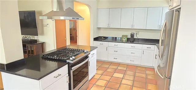 a kitchen with granite countertop a stove and a refrigerator