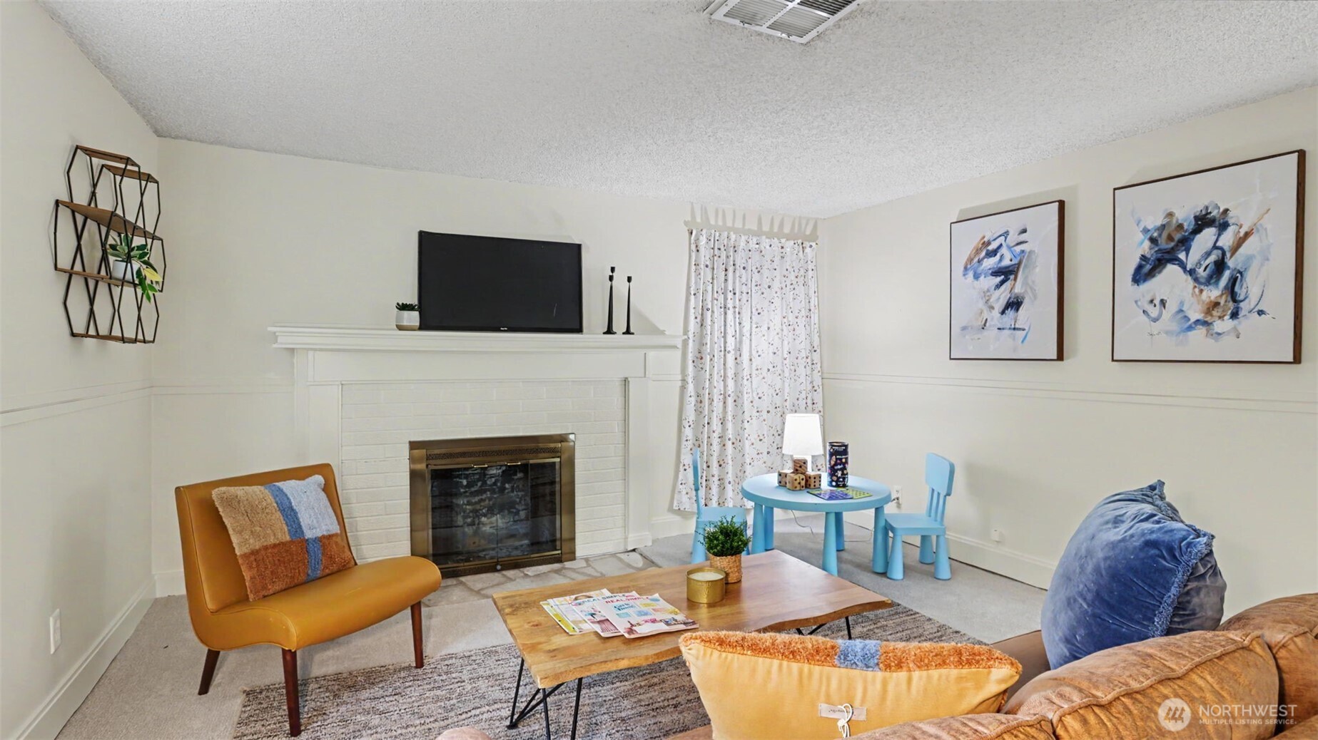 12515 Southeast 171st Street Renton, WA 98058 - Photo 14 of 24 a living room with furniture a fireplace and a flat screen tv