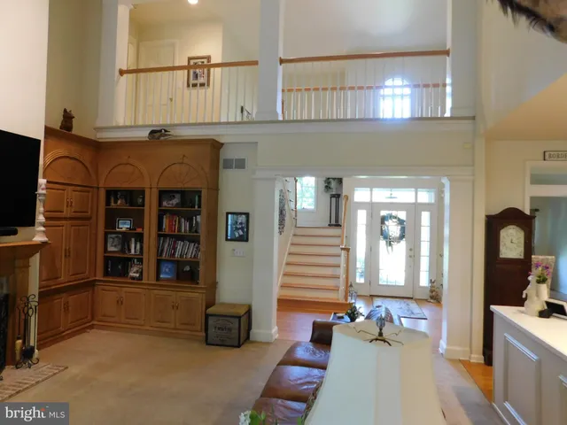 a living room with furniture and floor to ceiling window