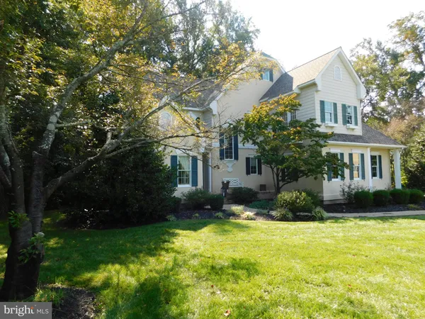 a view of a house with backyard sitting area and garden