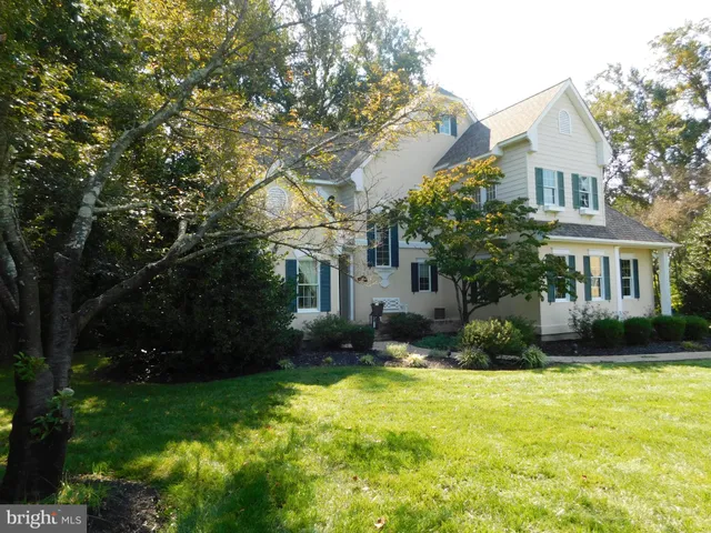 a view of a house with backyard sitting area and garden