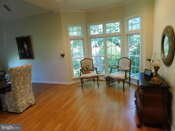 a bedroom with a bed and painting on the wall
