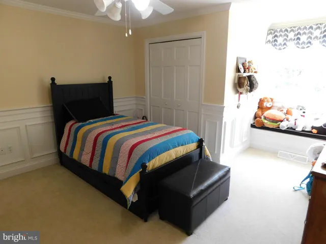 a view of a house with a large window and a yard