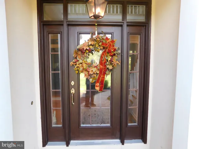 a kitchen with stainless steel appliances granite countertop a dining table and chairs