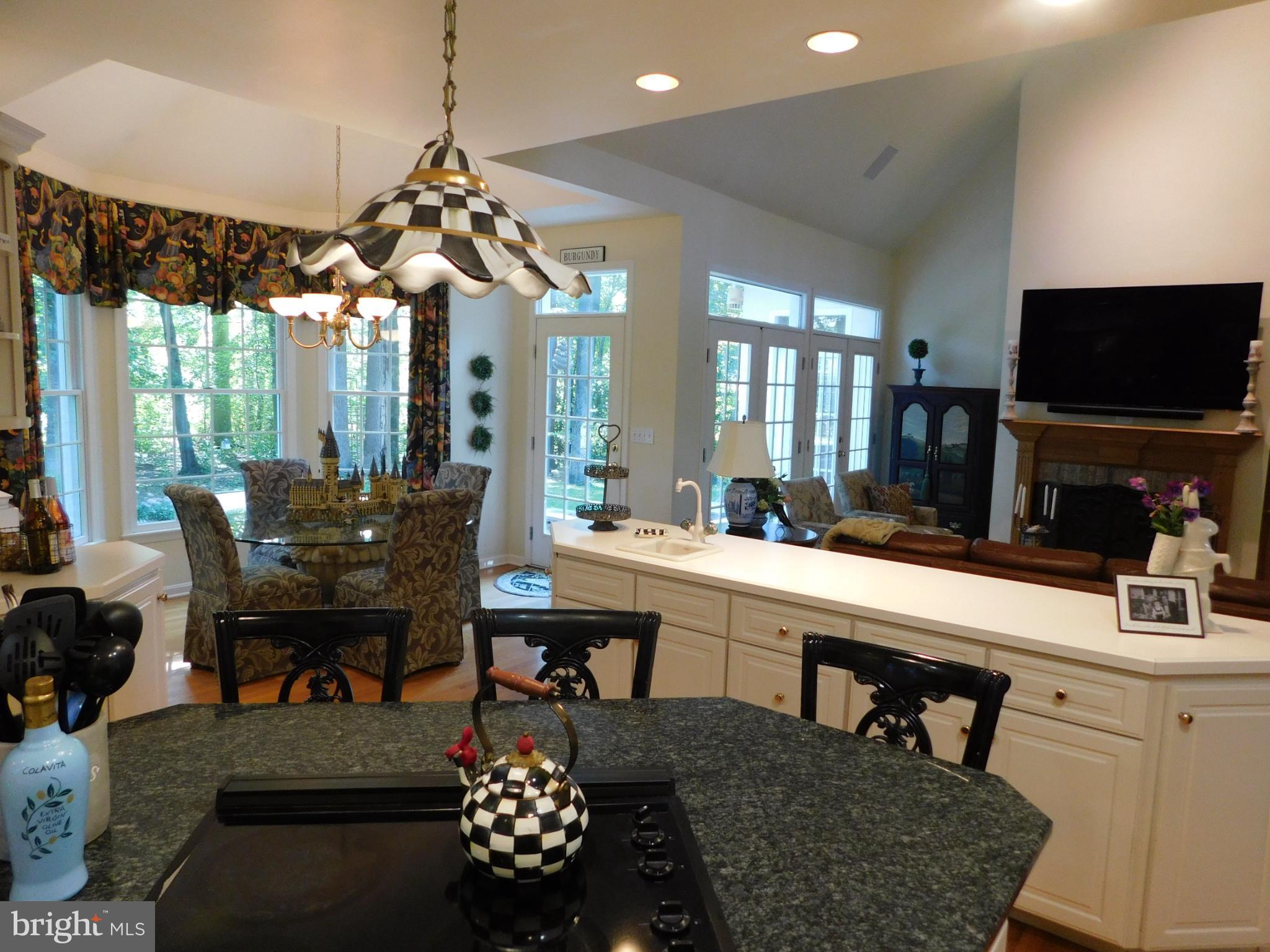 28 Baltray Road Dover, DE 19904 - Photo 9 of 73 a room with a table chairs and a flat screen tv