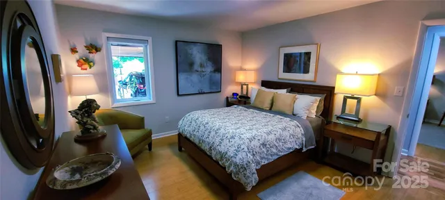 a bedroom with a bed and a flat tv screen on a dresser